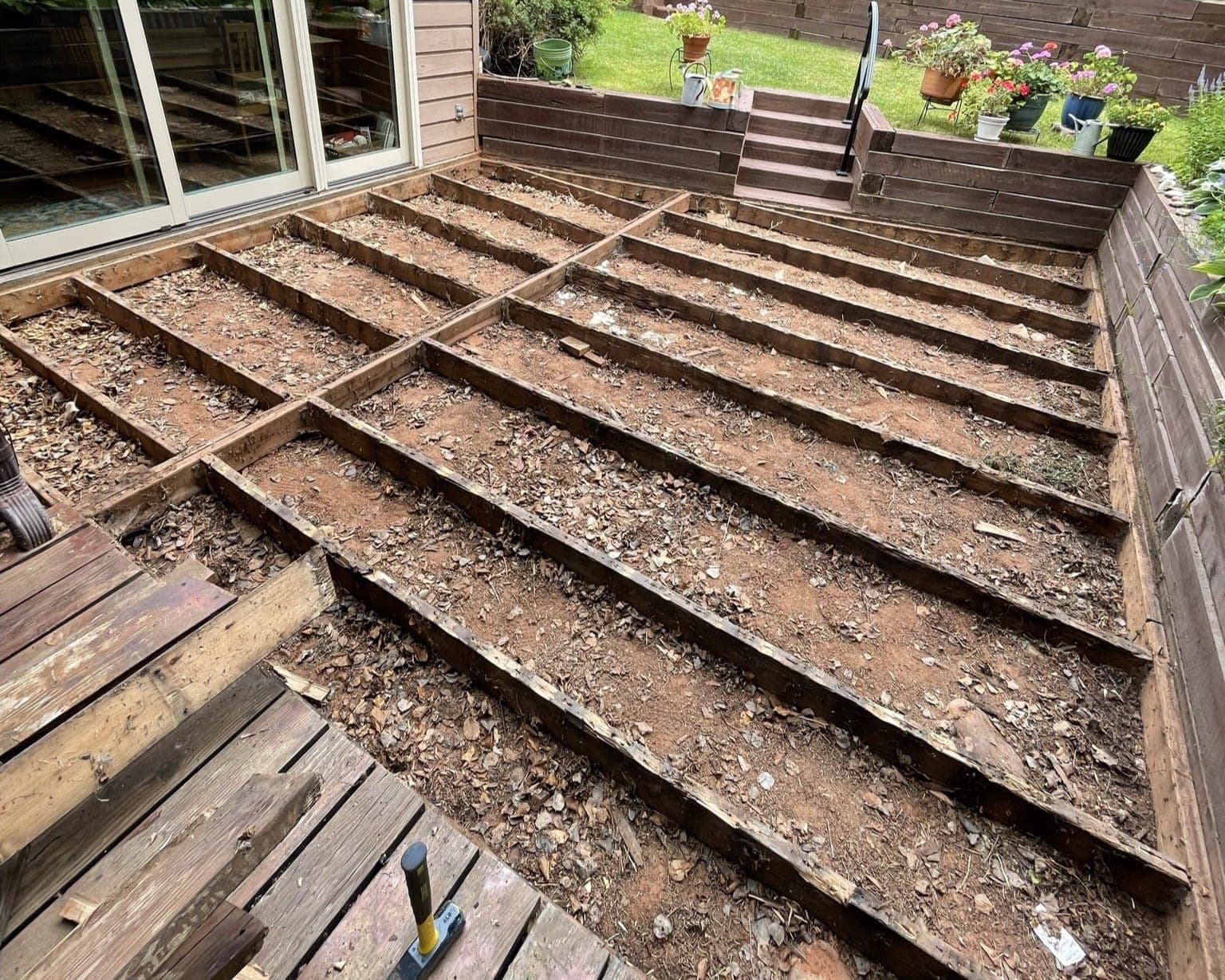 Deck stripped to its joists before rebuilding