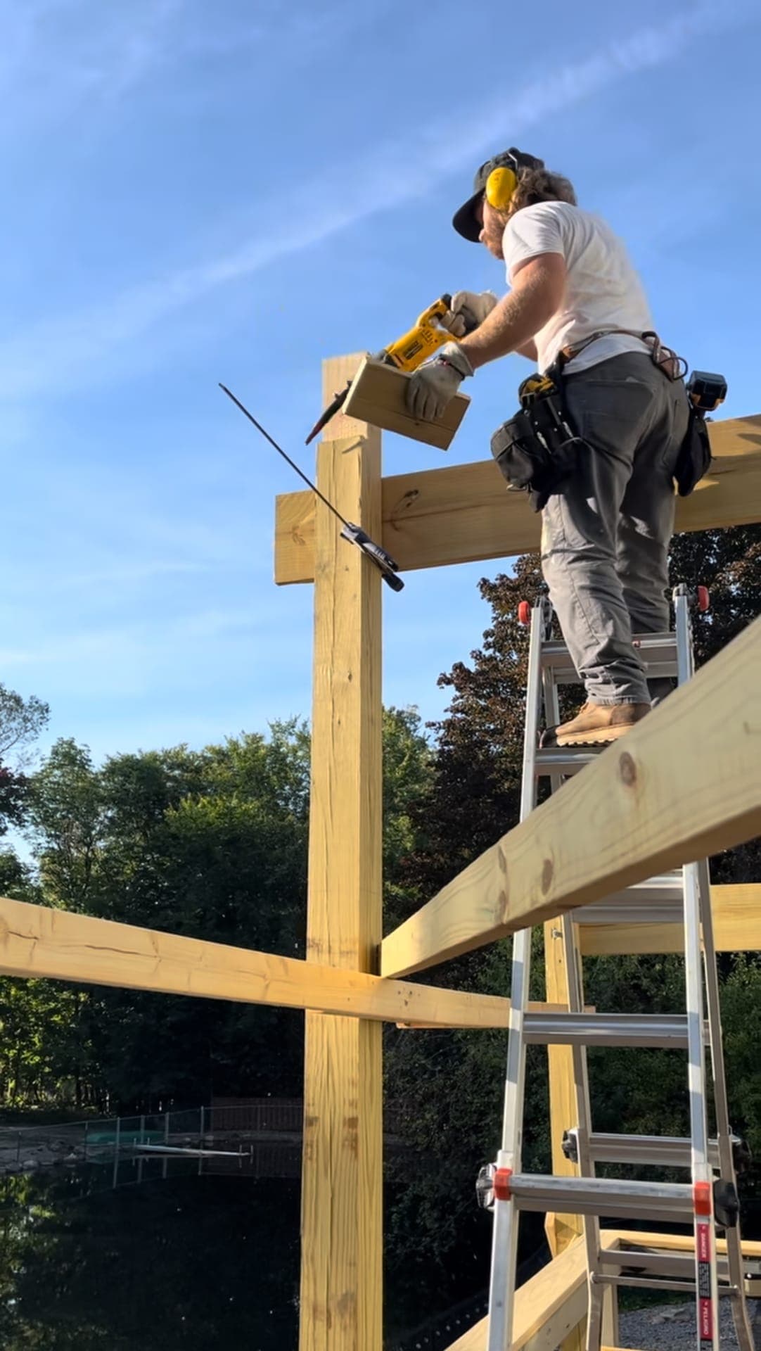 Stoney Ridge Services craftsman framing a custom gazebo from a ladder